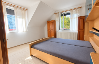 Bright Attic Bedroom with Wooden Furnishings